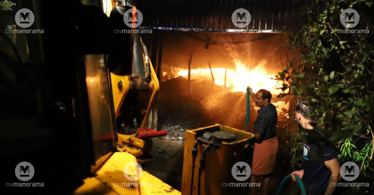 People of the locality attempt to douse the fire at a godown in Kozhikunnu near Mulankunnathukavu in Thrissur on Tuesday. Photo: Special arrangement 