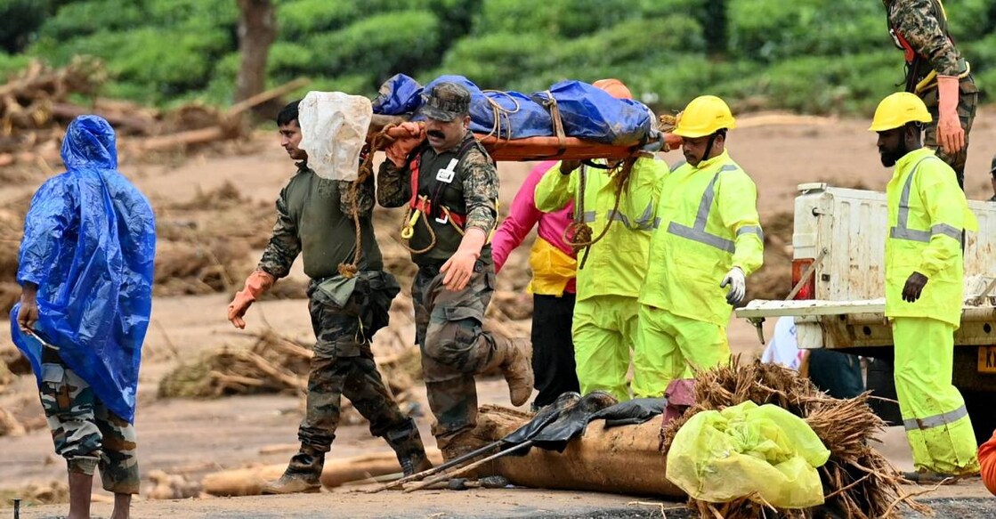 Relief personnel carry the body of a deceased, during a search and rescue operation after landslides in Wayanad. Photo: AFP