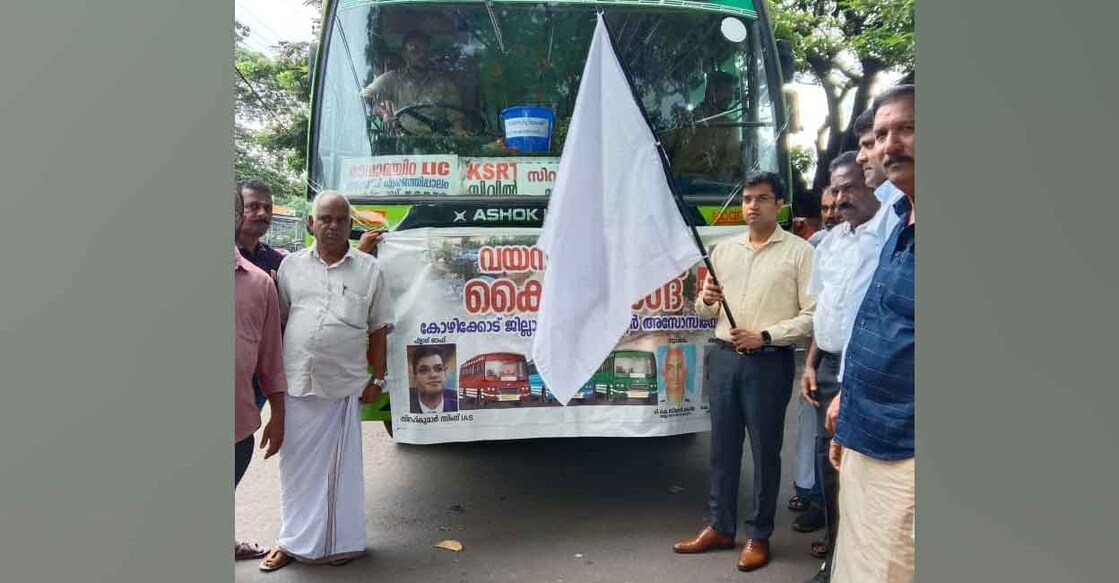 Kozhikode district collector Snehil Kumar Singh flags off a bus service for Wayanad landslide relief at the Collectorate on Thursday. Photo: Special arrangement