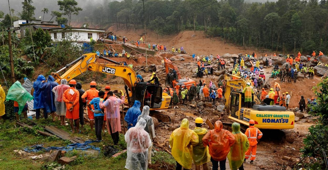 People watch as search operations are carried out after landslides hit Mundakkai village in Wayanad district. Photo: Reuters