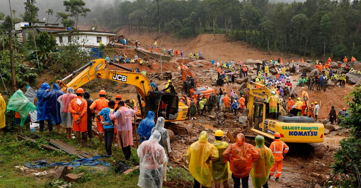 People watch as search operations are carried out after landslides hit Mundakkai village in Wayanad district. Photo: Reuters
