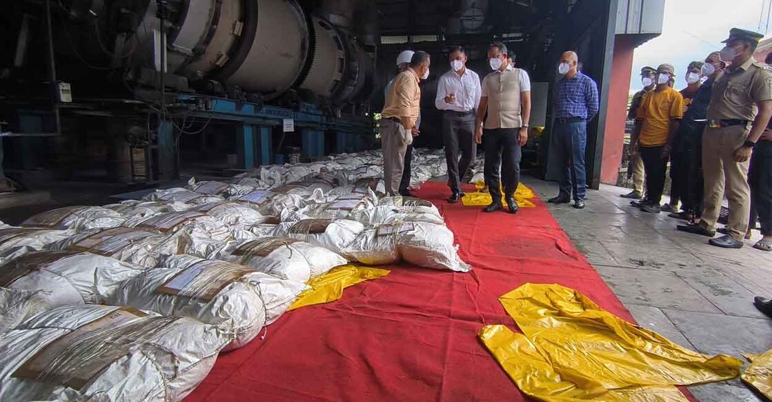 Officials look on as sacs containing the seized drugs are kept ready for disposal at Ambalamedu near Kochi on Tuesday. Photo: Special arrangement