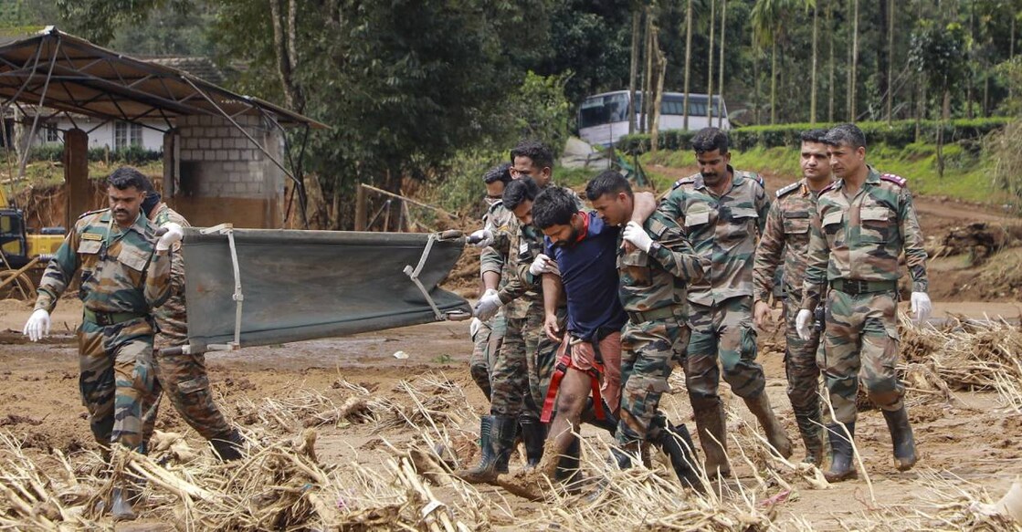 Army personnel take a man injured in the landslide in Wayanad to hospital. Photo: PTI