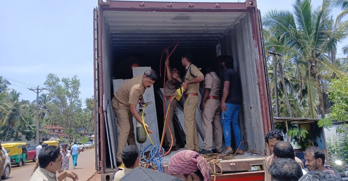 Fire and rescue personnel working to lift the marble slabs and free Jameen Khan, trapped underneath, at Bekal on Friday. Photo: Special Arrangement