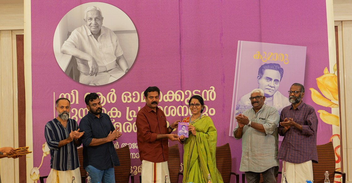 Writer Subhash Chandran re-releasing "Kumaru", a novel by C R Omanakuttan, by handing over a copy to S Saradakutty. (From left) Unni R, Santhosh Echikkanam, CICC Jayachandran and Sunil P Elayidom look on. Photo: Special arrangement
