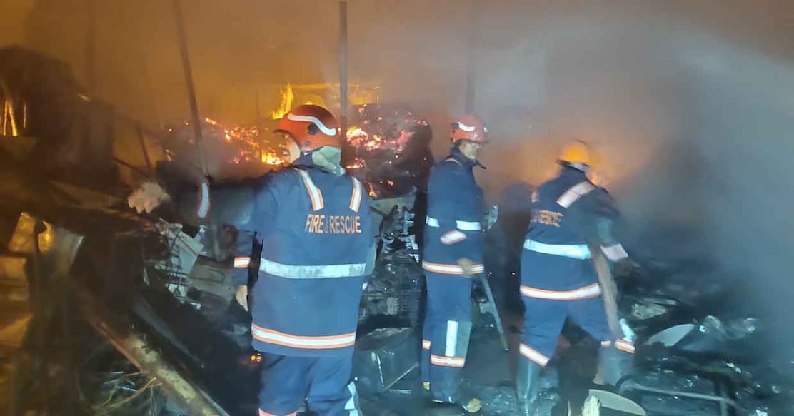 Fire & Rescue personnel extinguish the fire at a make-shift godown at Perumanna in Kozhikode. Photo: Special arrangement 