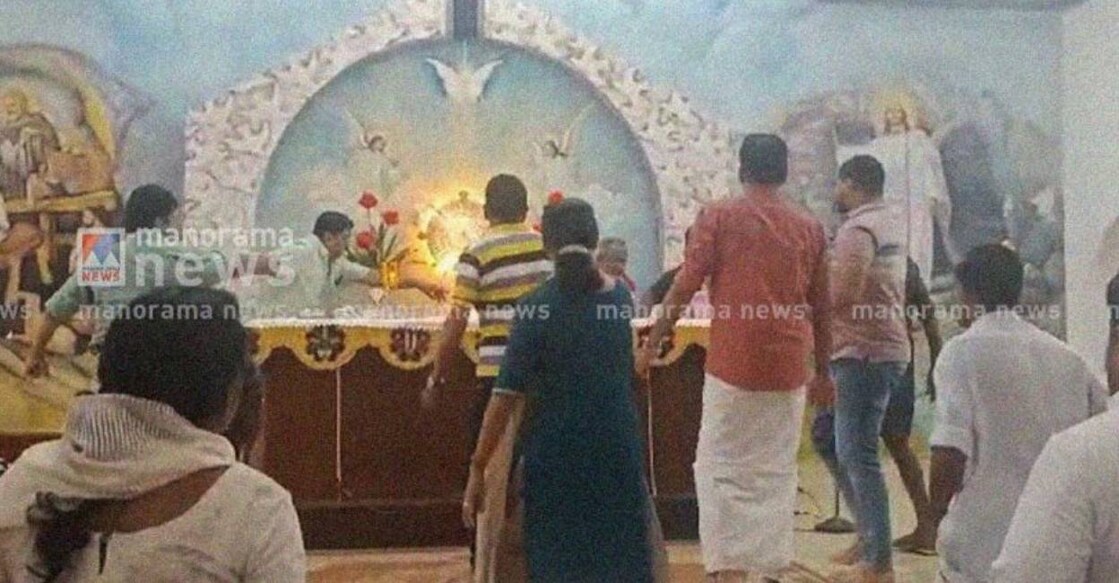 kottayam-church-clash A group of angry devotees attacked the priest in charge, John Thottuppuram, in an attempt to prevent him from performing the unified Holy Mass. Photo: Manorama News