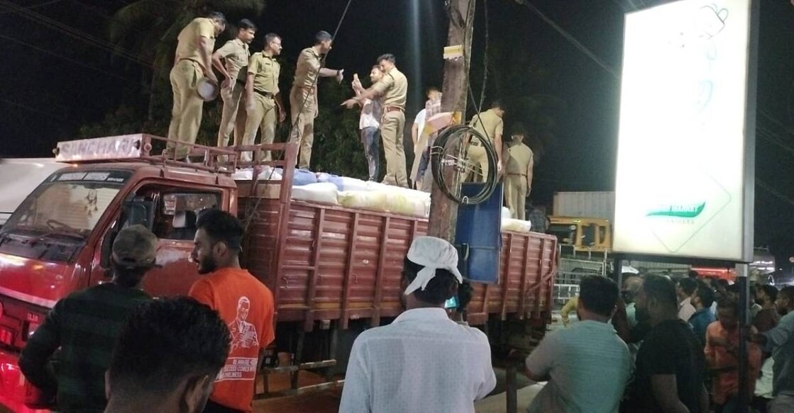 Officials inspect the lorry that carried spirit. Photo: Special Arrangement