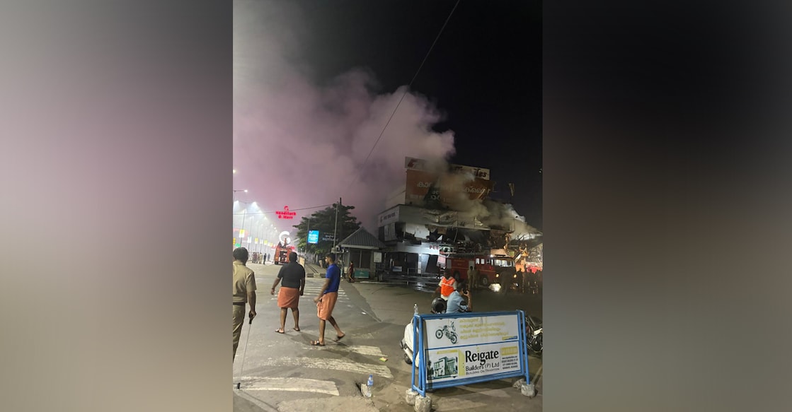 kozh-fire Smoke filled the area as fire raged in the three-storey textile showroom in Kozhikode. Photo: Special Arrangement