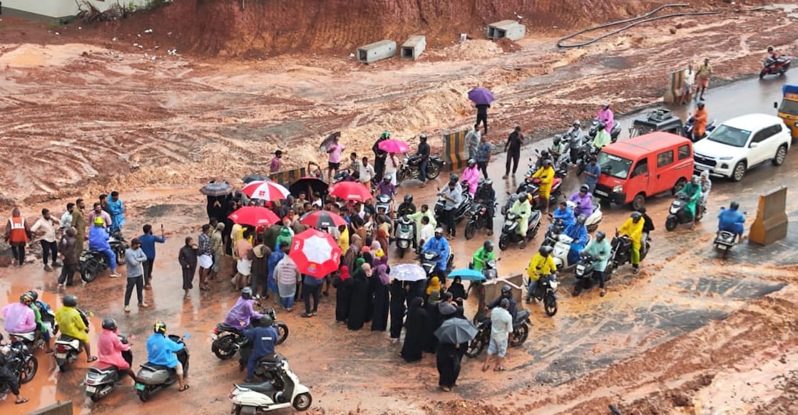 After a second wave of slush flooded their homes, residents of Kuppam - 2 kms north of Taliparamba - blocked the under-construction NH66 Wednesday morning, demanding immediate action. Photo: Special Arrangement