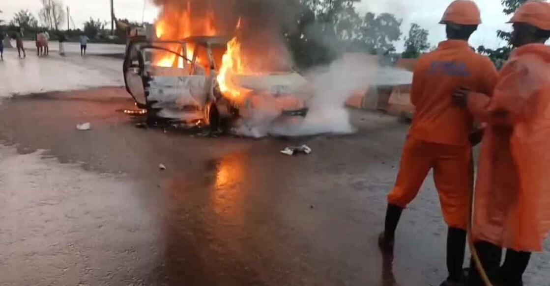 Firefighters trying to douse the car on fire. Photo: Special Arrangement.