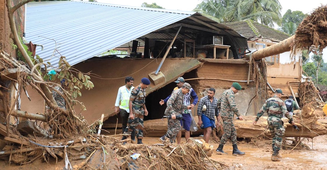 Residents being taken to safety by rescue workers in Chooralmala. Photo: Albin Mathew.