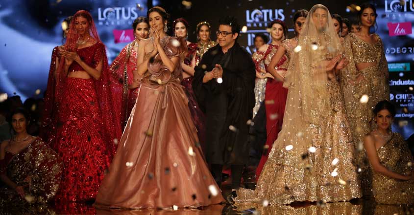 New Delhi: Models showcase a creation of fashion designer Suneet Varma on the second day of Lotus India Fashion Week in New Delhi, on March 14, 2019. (Photo: Amlan Paliwal/ IANS) New Delhi: Models showcase a creation of fashion designer Suneet Varma on the second day of Lotus India Fashion Week in New Delhi, on March 14, 2019. (Photo: Amlan Paliwal/ IANS)