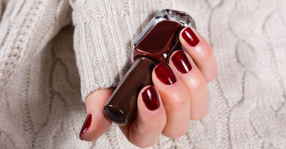The cherry cola nail trend lends a mesmerizing vampy look to the nails. Photo: Emilija Randjelovic/iStock