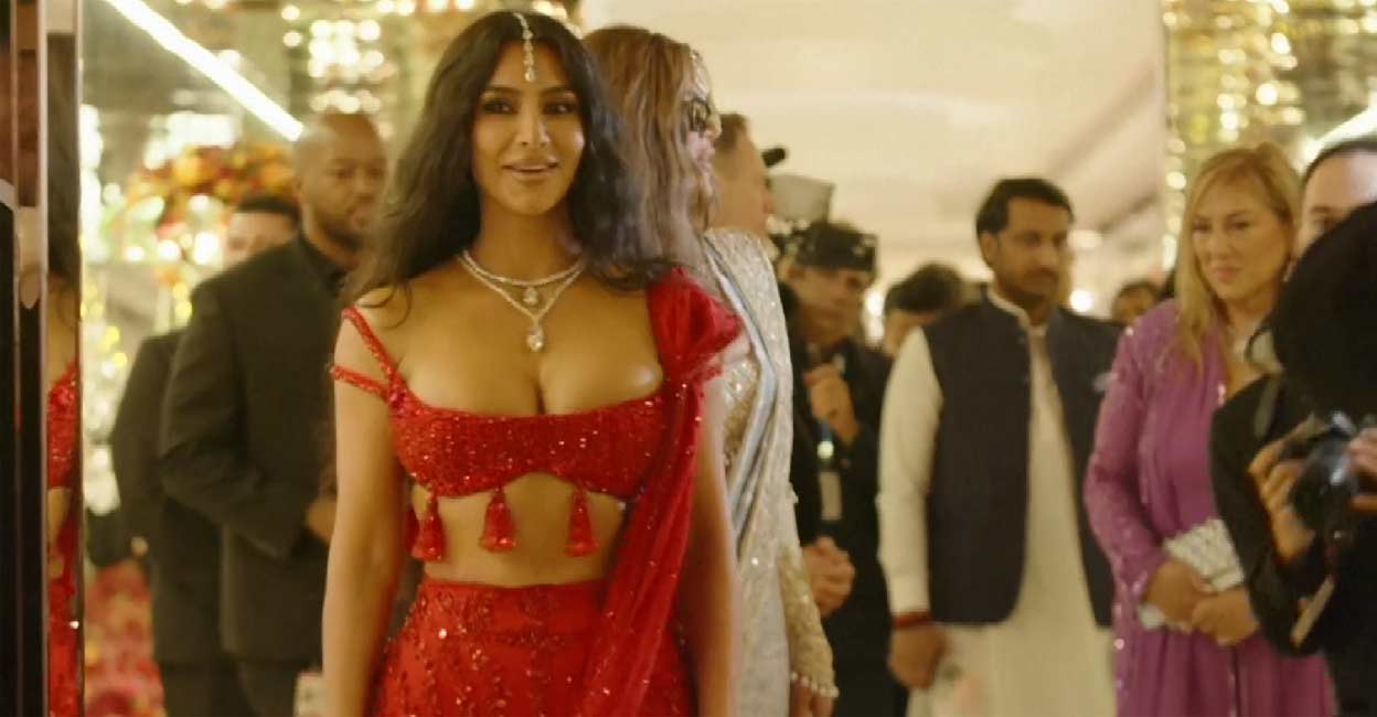 Kim Kardashian wore a dazzling red lehenga at the wedding ceremony. Image courtesy: Screen grab of AFP video