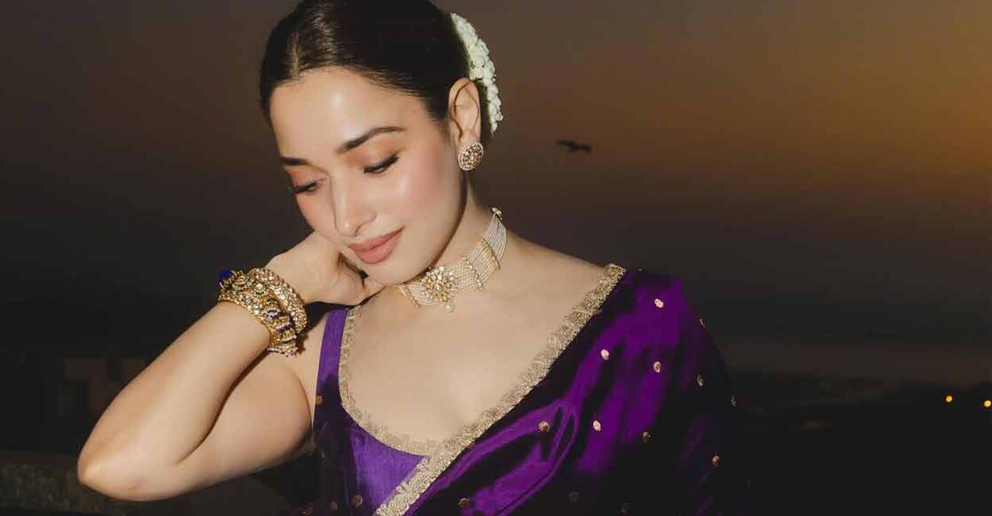 Tamannaah Bhatia matched her purple sari with a round chocker necklace, garnet hair and nude makeup. 