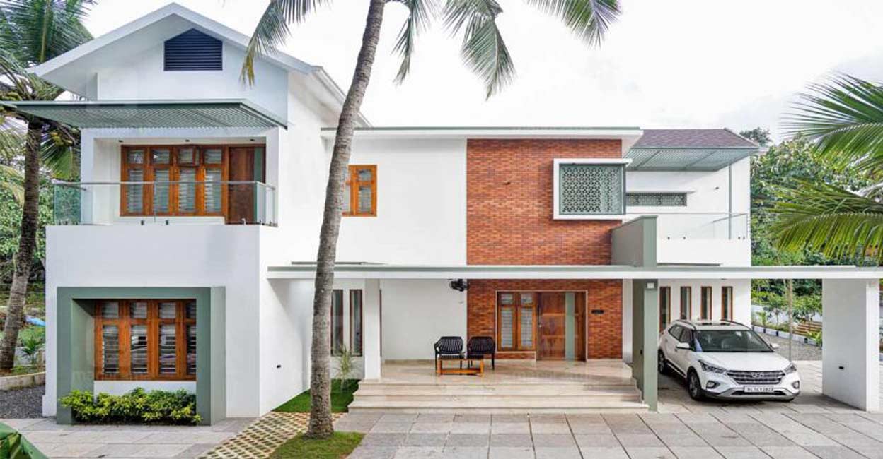 nri-house-kottakal-front-c The fusion style elevation is chic and exudes elegance.