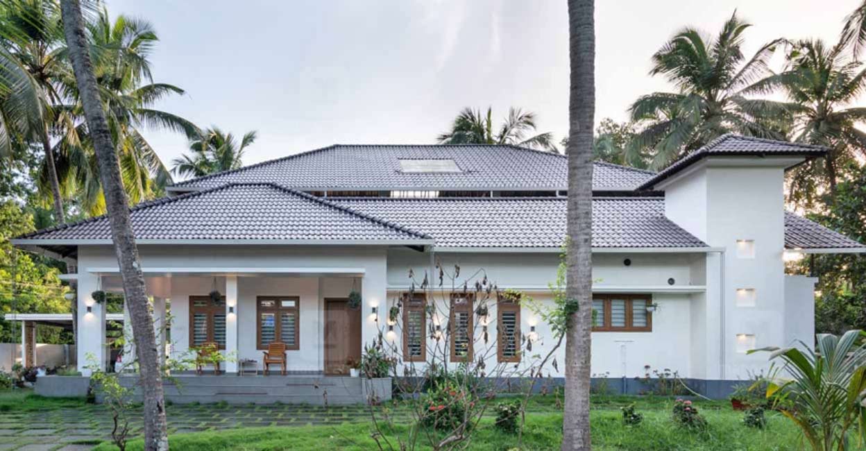 Malappuram house The GI truss installed on top of flat roof is paved with tiles that adds a traditional charm to the elevation of the house.