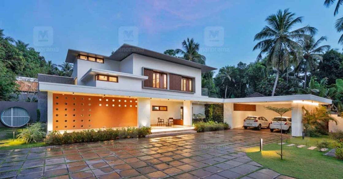 Palaakkad house The elevation dons the elegant colour combination of white and red.