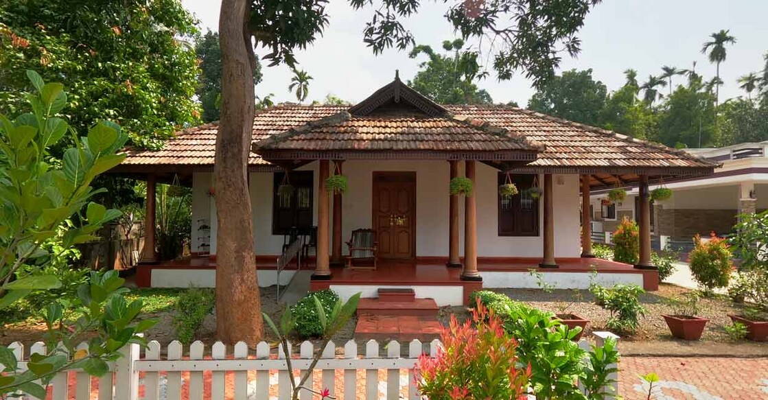 The pillars crafted in mahogany are the highlights of the traditional sit-out.