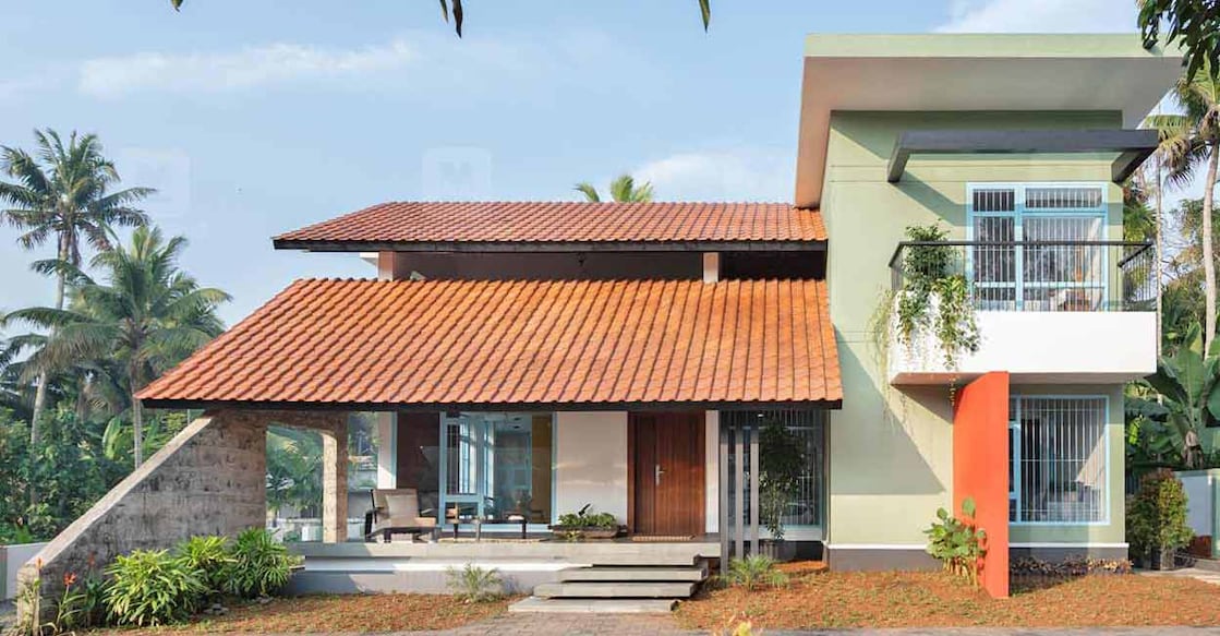 Kottayam Half of the elevation has a slanted roof that is paved with mud roofing tiles while the rest has been designed as a flat box structure. Photo: Special arrangement