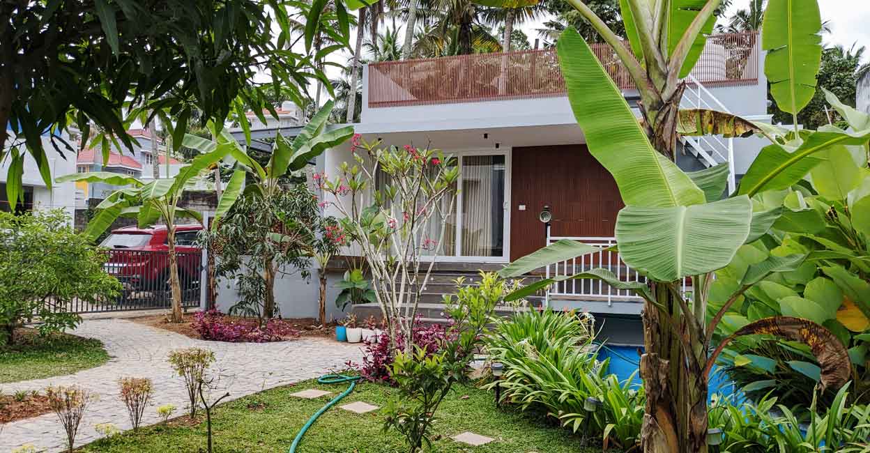 The living area, dining space and mini kitchen are arranged in the open hall of the house designed in 550 sq ft.