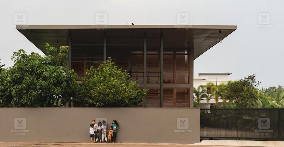 taliparamba-house-01-c The contemporary designer elements in RCC slabs and the wooden louvers add an alluring charm to the elevation. Photo: Special arragement
