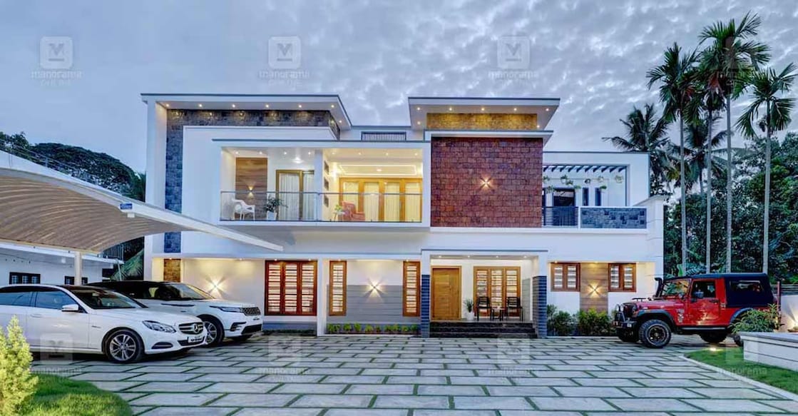 harippad-house-01-c The elevation designed in the classic white and grey colour theme, is highlighted with cladding tiles and laterite texture works. Photo: Special arrangement