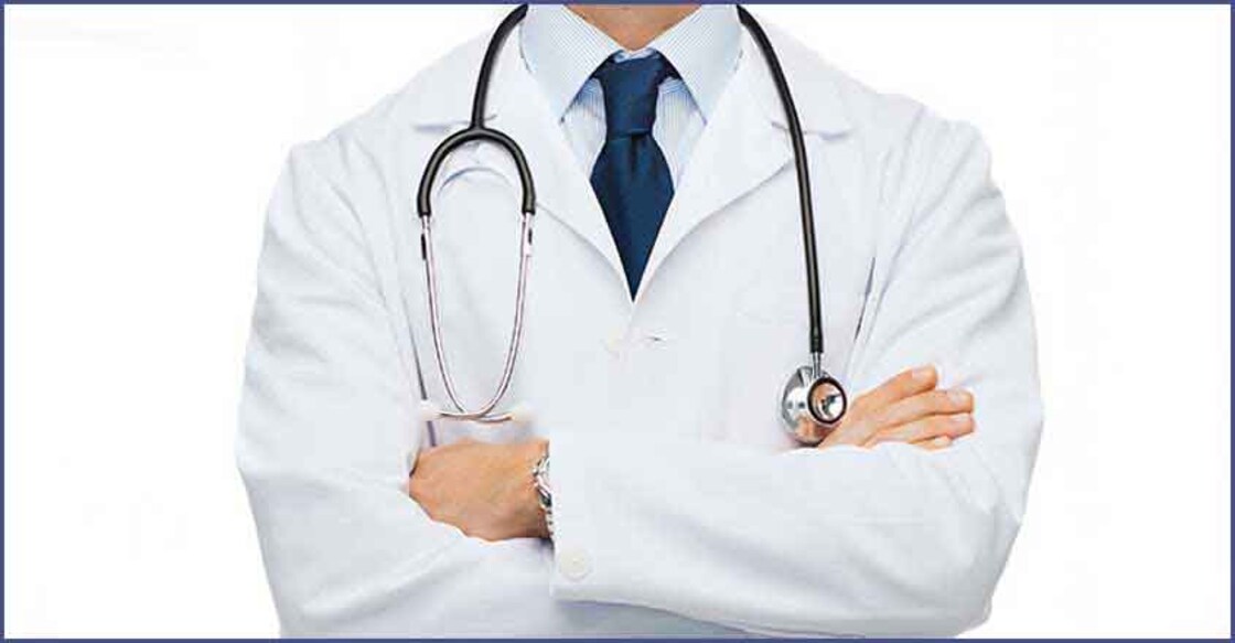 smiling male doctor in white coat at hospital
