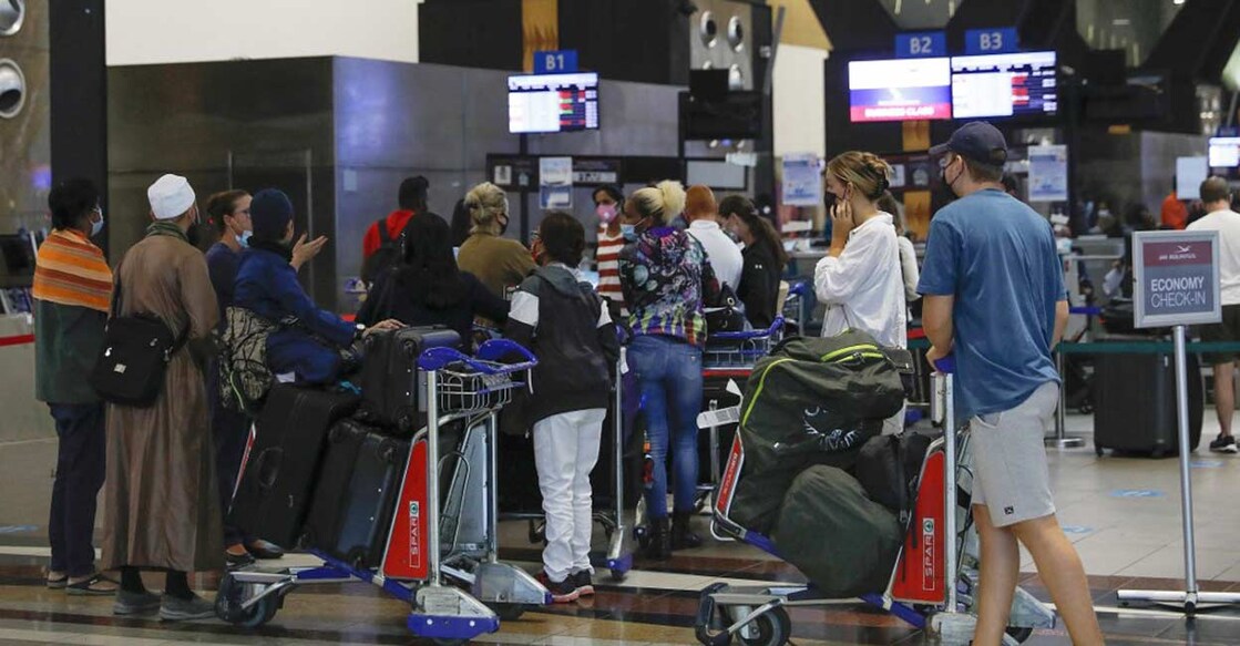 Travellers queue at a check-in counter at OR Tambo International Airport in Johannesburg after several countries banned flights from South Africa following the discovery of a new Covid-19 variant Omicron. Photo: AFP/Phill Magakoe