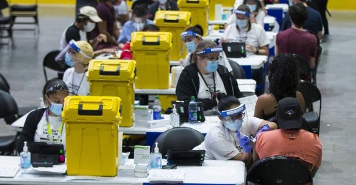 People receive the COVID-19 vaccine at a mass vaccination site in Toronto, Canada, on June 27, 2021(Photo by Zou Zheng/Xinhua/IANS) Image used for representational purpose: IANS