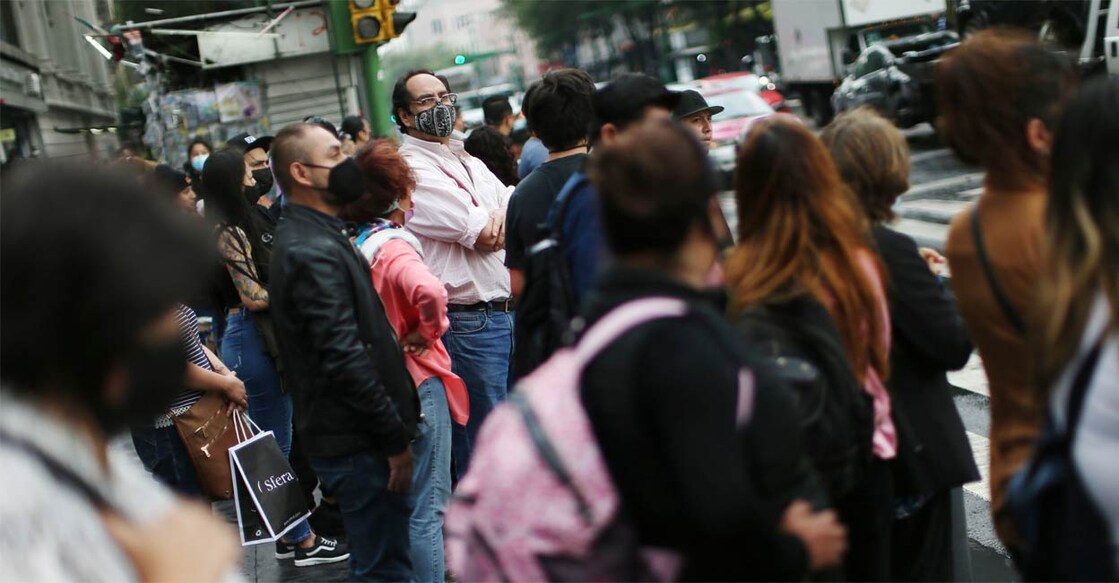 People wearing face masks wait at a traffic junction in Mexico City. Photo: Reuters/Edgard Garrido/file