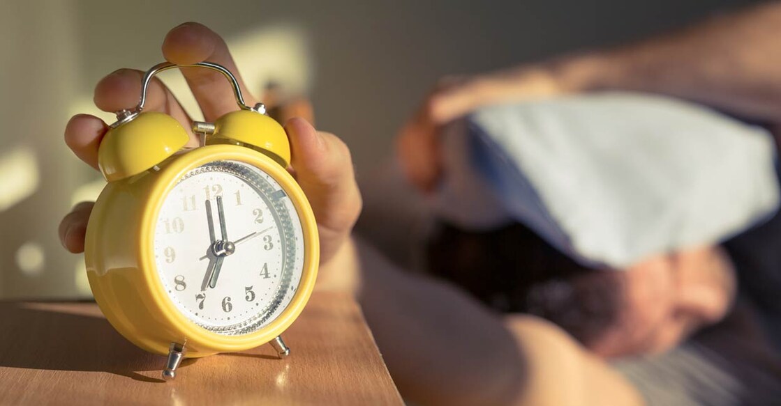 The most common reason for snoozing is feeling too tired to get out of bed when the alarm goes off. Photo: SrdjanPav/istock