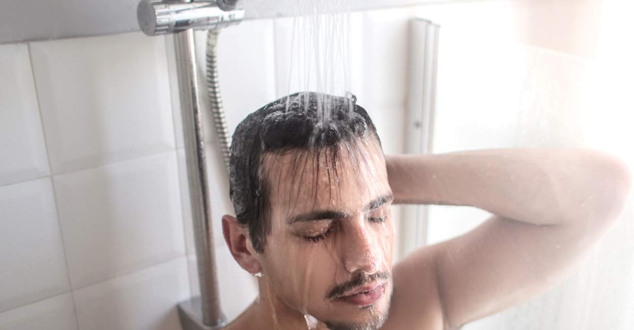 570702676 Man warming up in the shower