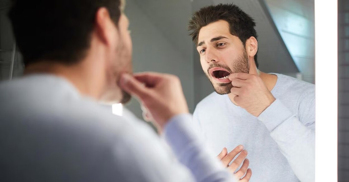 Smoking, alcoholism, poor oral health, and family history of oral cancer are some of the factors that increase the risk of oral cancer.  Photo: iStock/shironosov