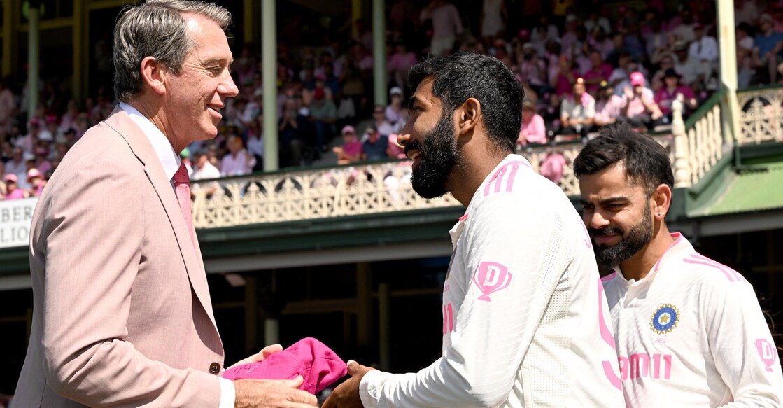 Australia’s former cricketer Glenn McGrath (L) receives a pink cap from India’s captain Jasprit Bumrah (C) on Jane McGrath Day, which honours the former Australian fast bowler's late wife, on day three of the fifth Test match between Australia and India at the Sydney Cricket Ground on January 5, 2025. Photo: AFP/Saeed Khan