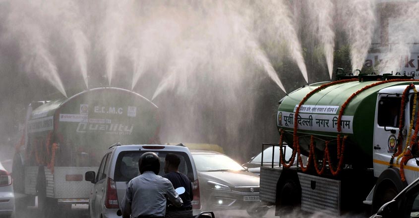 New Delhi: East Delhi Municipal Corporation (EDMC) tankers sprinkles water on a street as a measure to curb pollution in New Delhi on Oct 16, 2019. (Photo: IANS)