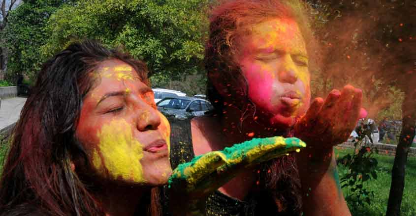 Amritsar: Students of Guru Nanak Dev University celebrate Holi ahead of the festival at university campus in Amritsar, on March 19, 2019. (Photo: IANS)
