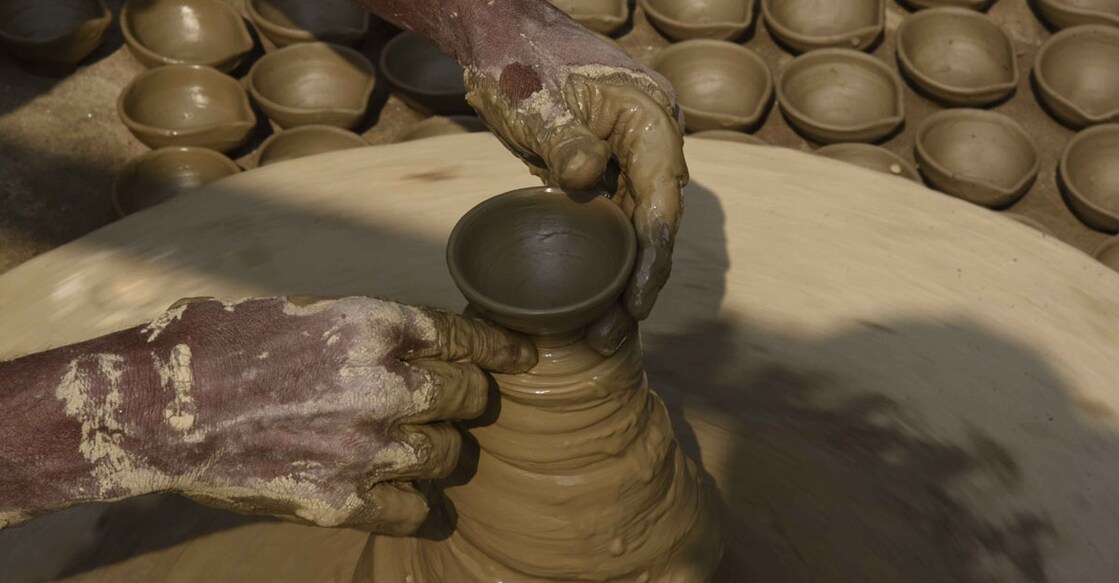 Patna: A potter sculpts clay to make earthen lamps ahead of Diwali celebrations, in Patna on Nov 5, 2020. (Photo: IANS)