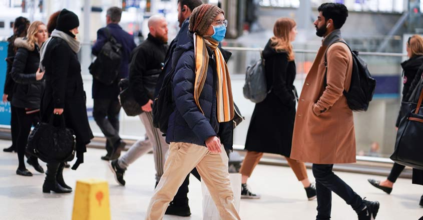 HEALTH-CORONAVIRUS-BRITAIN A man wearing protective face mask walks through Waterloo station, as the number of coronavirus cases grow around around the world, in London, Britain. Photo: Reuters
