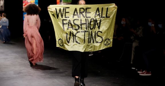 Climate change protester sneaks in to walk runway at Dior in Paris ...