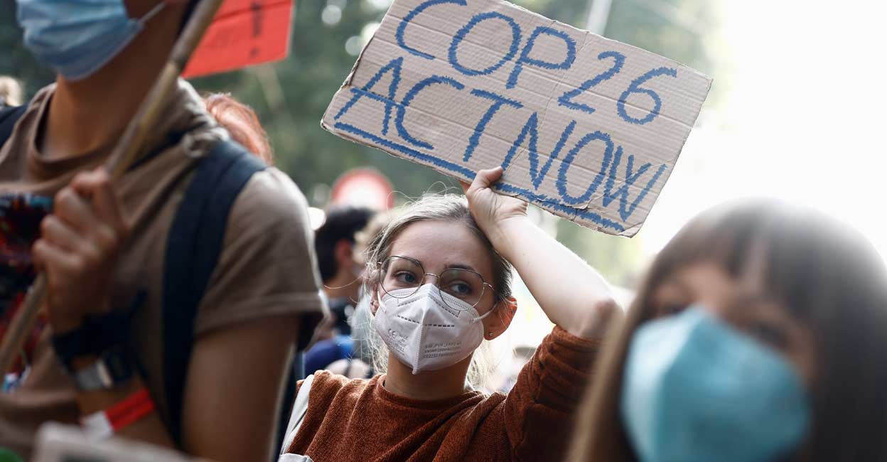 People take part in the 'Global march for climate justice' while environment ministers meet ahead of Glasgow's COP26 meeting, in Milan. REUTERS/Guglielmo Mangiapane/file