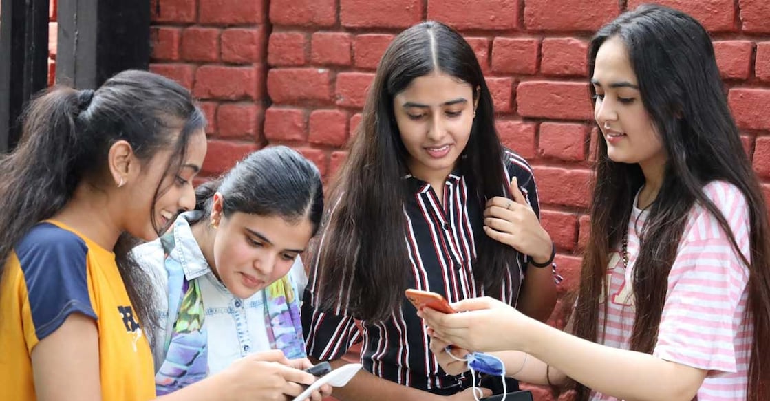 New Delhi: Students check their results on their smartphone after the CBSE declared results for Class 12 Board examinations, in New Delhi on July 13, 2020. (Photo: IANS) Class 12 examination is important as it is decisive for admission to a university. Image courtesy: IANS