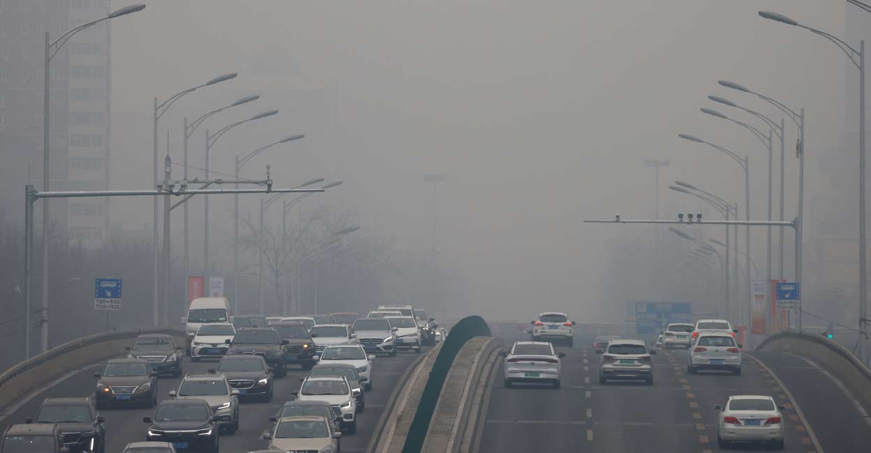 Cars move on a road during a day with polluted air, following the outbreak of the coronavirus disease, in Beijing, China. Photo: REUTERS/Carlos Garcia Rawlins/File
