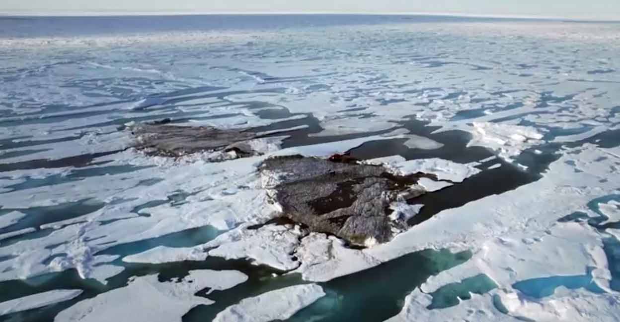 An aerial view of a tiny island off the coast of Greenland revealed by shifting pack ice. Image courtesy: JULIAN CHARRIERE/via REUTERS TV
