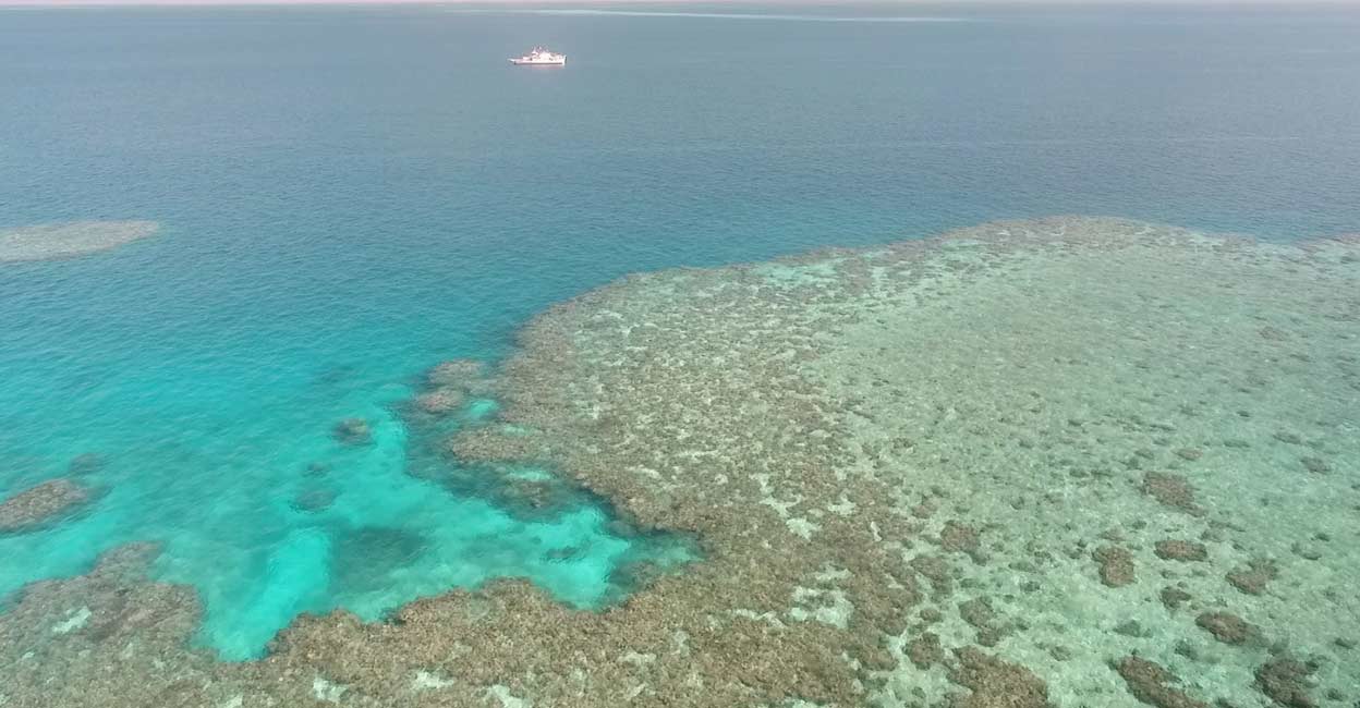 AUSTRALIA-CLOUD-BRIGHTENING A general view of Broadhurst Reef and a research vessel during the second field trial at Broadhurst Reef on the Great Barrier Reef, Queensland, Australia (file photo). Image courtesy: Handout via Reuters