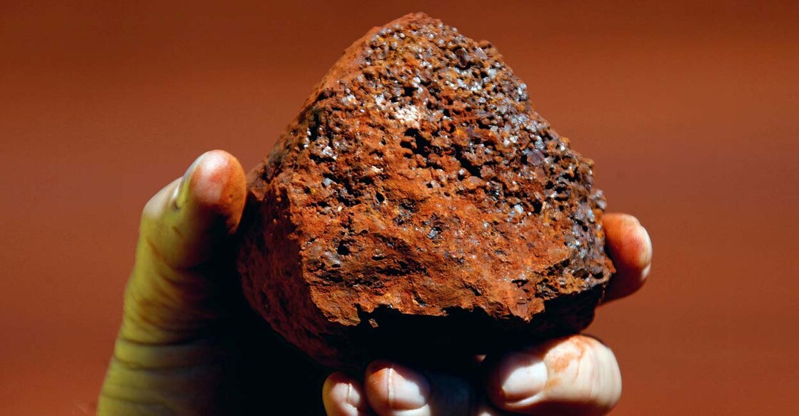 A miner holds a lump of iron ore at a mine located in the Pilbara region of Western Australia. Reuters/David Gray