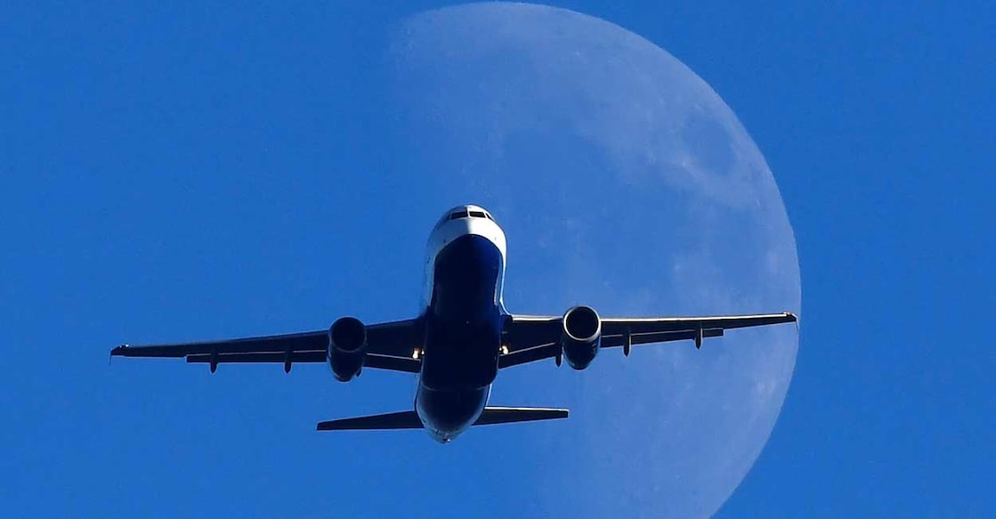 A passenger plane flies over London, Britain. File photo: REUTERS/Toby Melville