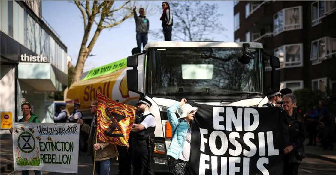 Activists from Extinction Rebellion occupy an oil tanker during a protest calling for an end to fossil fuels, in central London. Photo: Reuters/Henry Nicholls