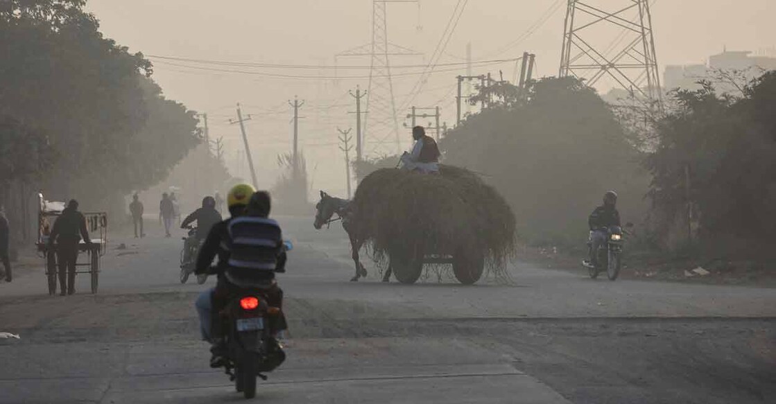 A horse cart crosses a road near dyeing units in Panipat. Photo: Reuters/Anushree Fadnavis